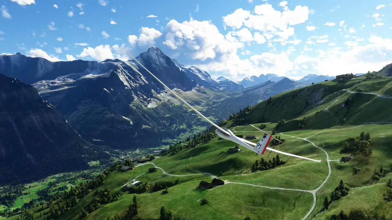 A white glider soaring over green alpine valleys and mountains