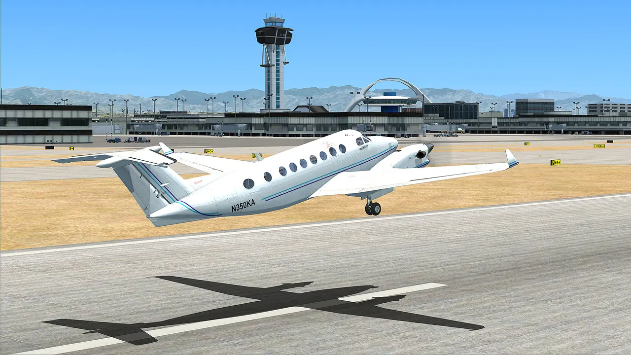 Flight Simulator X: a Beechcraft King Air taking off from a big airport, with the control tower and terminal behind