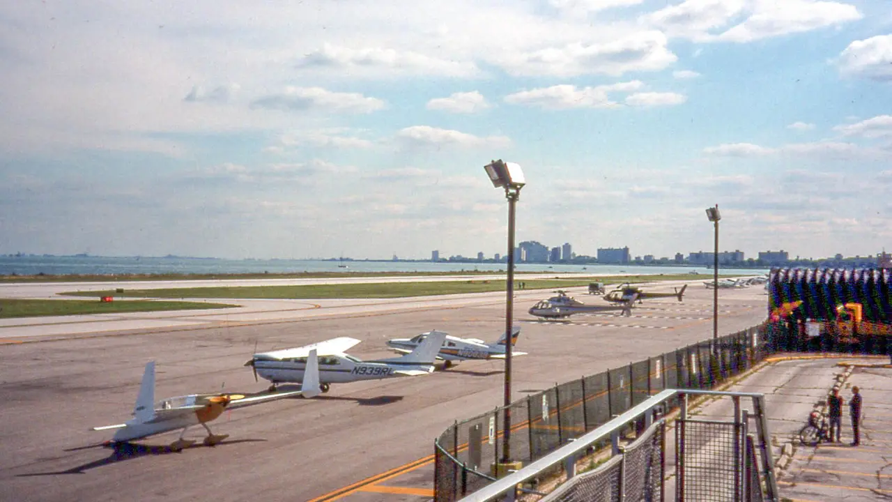 The real Meigs Field in 1997: small planes and helicopters parked by the runway, with Lake Michigan and the Chicago skyline beyond