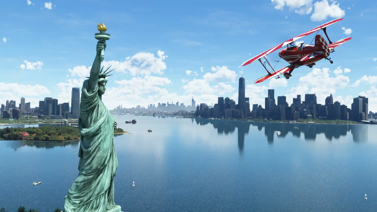 Microsoft Flight Simulator (2020): a red biplane flying past the Statue of Liberty with the Manhattan skyline behind