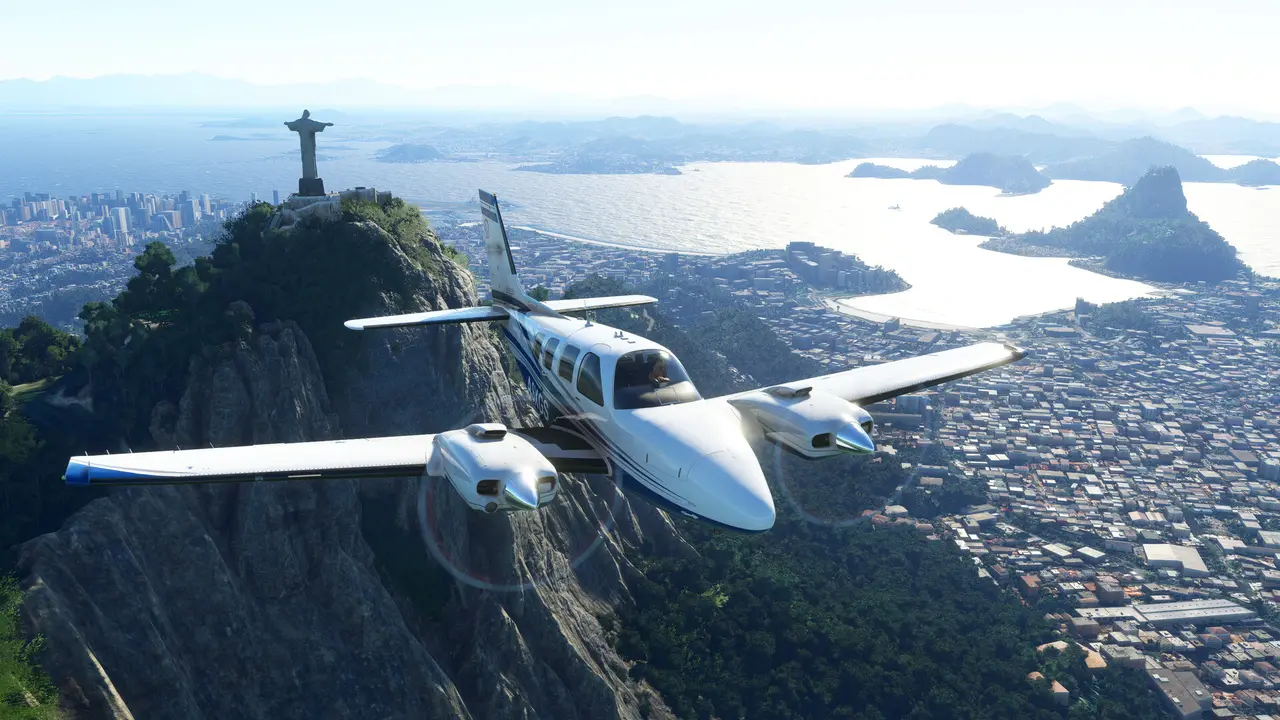 Microsoft Flight Simulator (2020): a twin-engine plane flying past the Christ the Redeemer statue above Rio de Janeiro